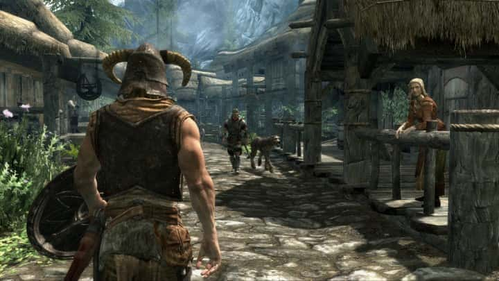 A character entering a village in Skyrim.