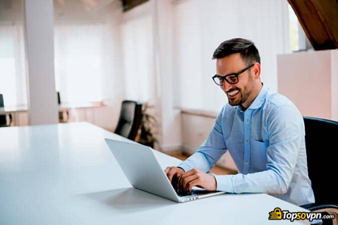 Types of VPN: a man typing something on his laptop.