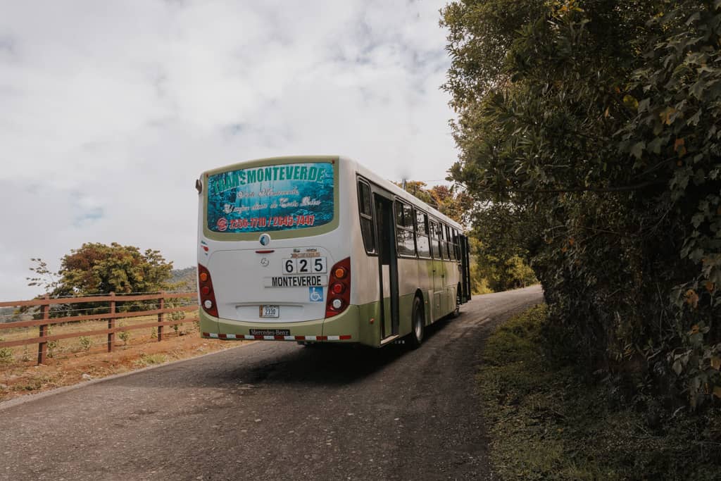 bus on road with greenery on the left heading toward Monteverde Cloud Forest reserve Costa Rica