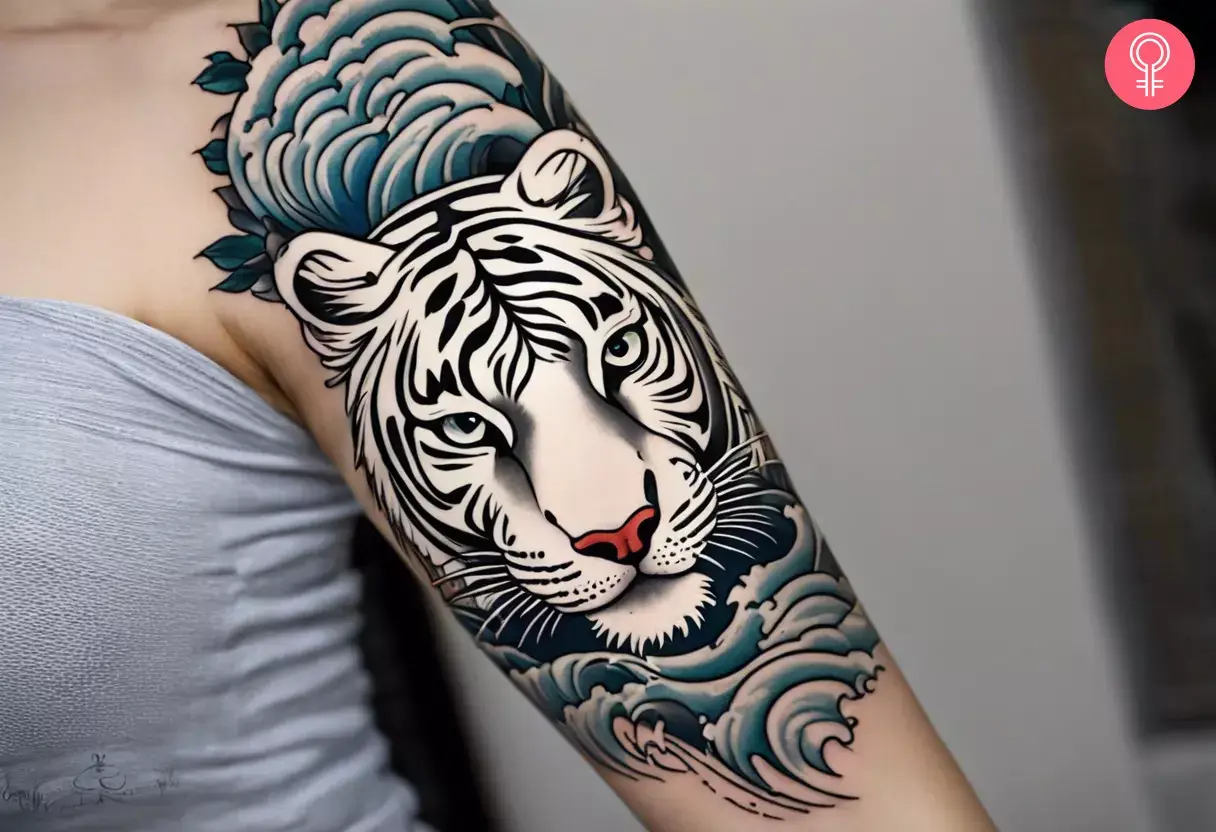 Upper arm tattoo of a Japanese white tiger and waves