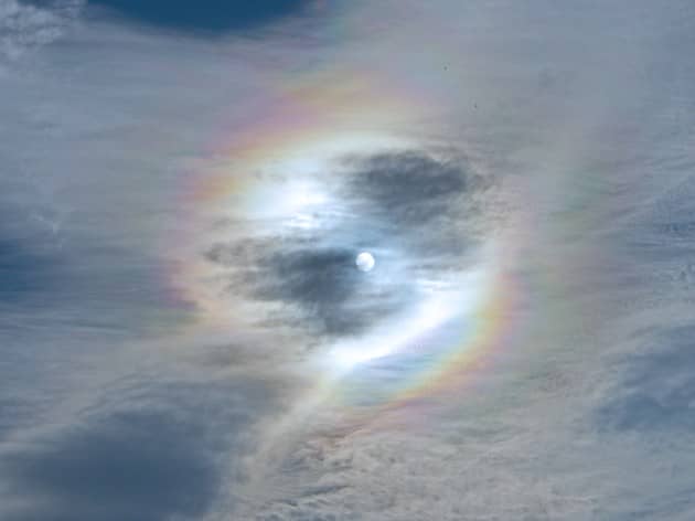 sun with rainbow and wispy  cloud