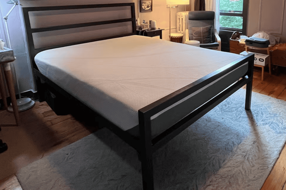 white and gray foam mattress from tempur pedic on a black bed frame