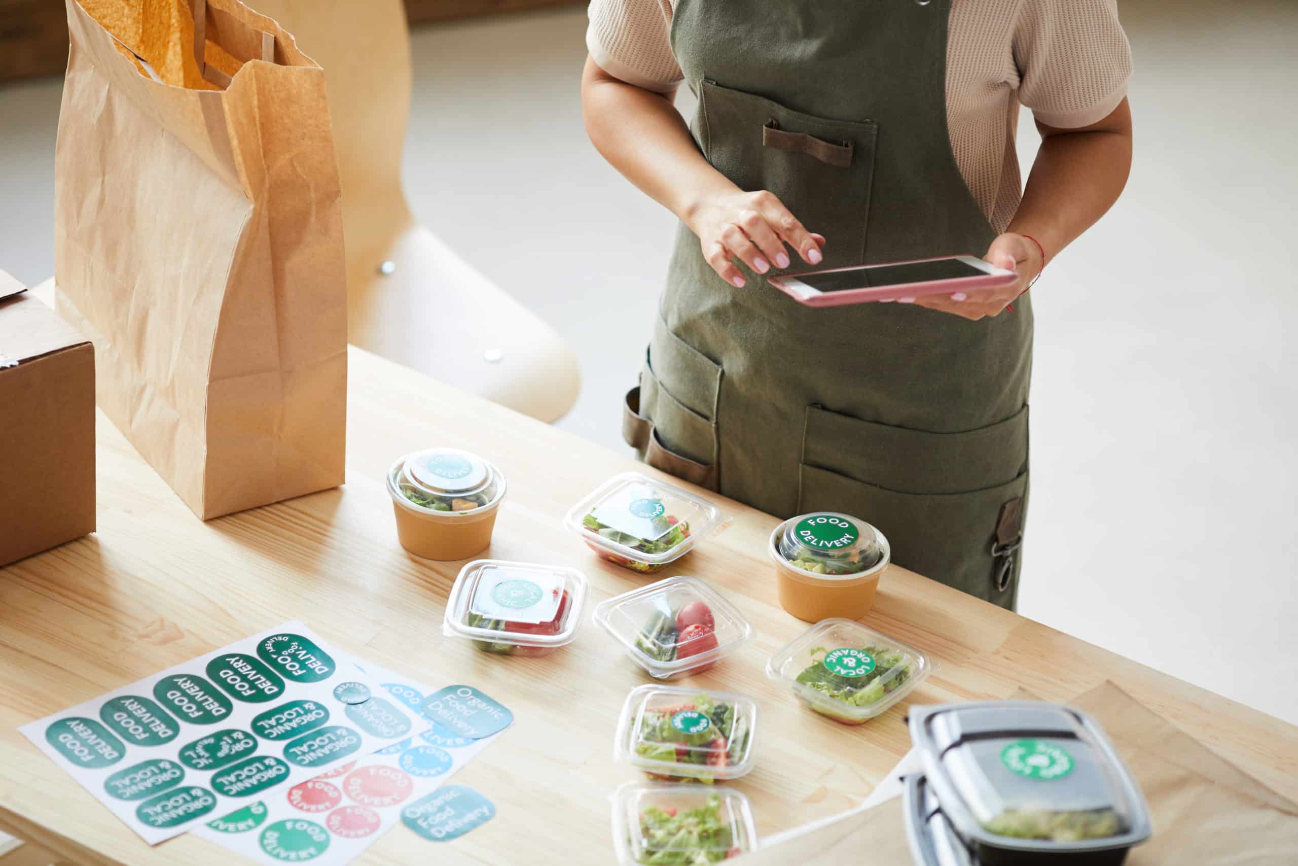 Food delivery business owner fulfilling online orders from a cloud kitchen in Dubai.