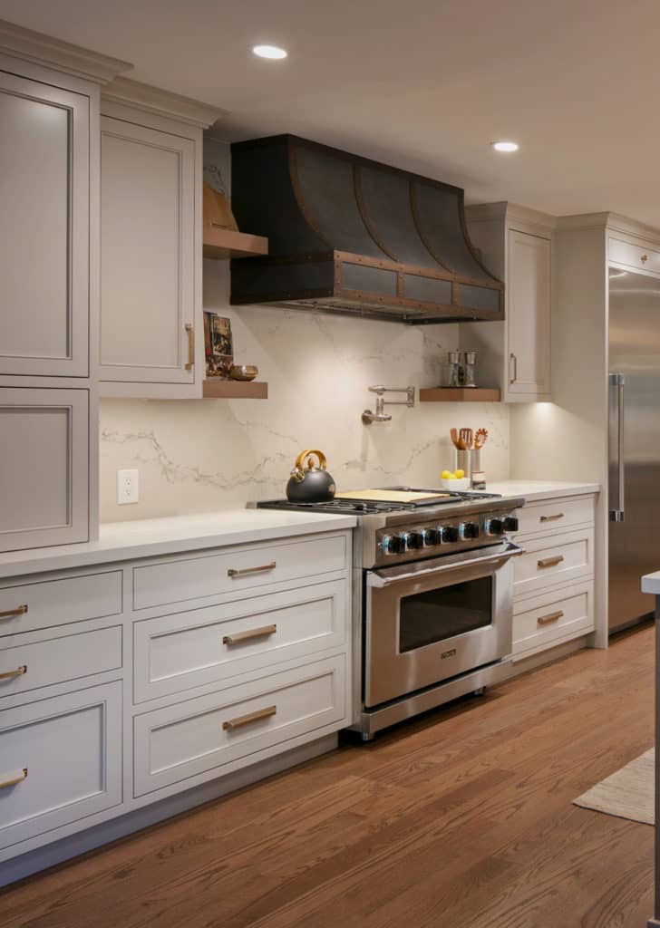 Kitchen in Benjamin MooreRevere Pewter (painted cabinets darkened) . Quartz countertops. Caesarstone Statuario Nuvo Red oak wood floor, Pendant lights, metal range hood, Kylie M Edesigns