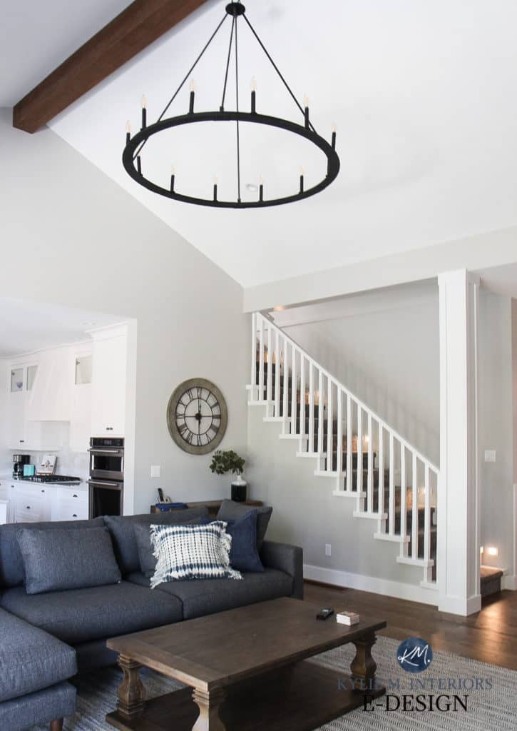 Living room, staircase, white spindles. Sherwin High Reflective White, Stonington Gray paint color on walls, Gray sectional. Kylie M Interiors diy online paint color consultant