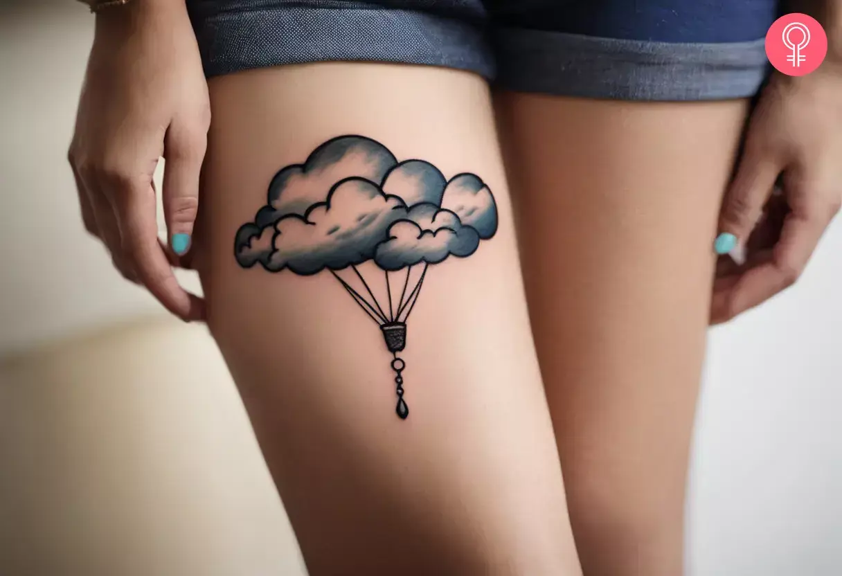 Small cloud tattoo on the thigh