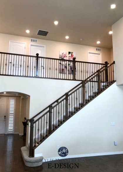 Benjamin Moore Navajo White 2 sotrey staircase and hallway. Best cream paint colour, dark wood floor and railing. North facing, northern Kylie M E-design client photo