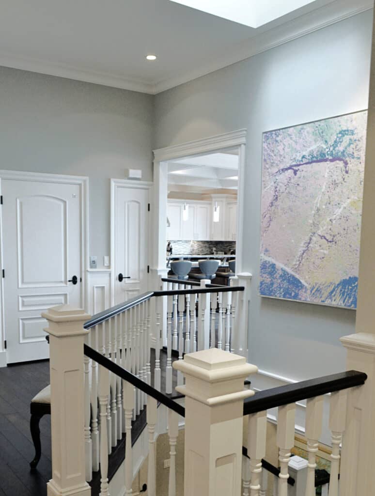 Benjamin Moore Stonington Gray walls, Oxford White doors, trims, railing, dark wood floor, artwork collection