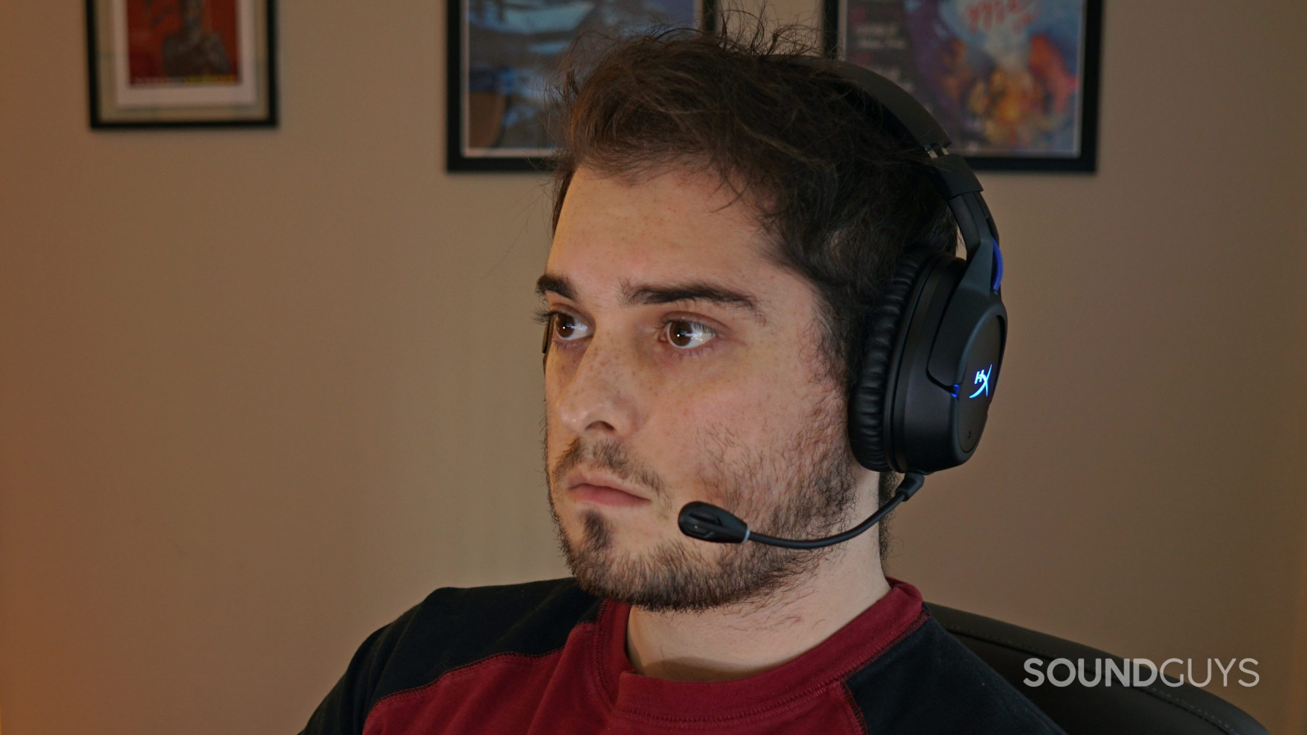 A man wears the HyperX Cloud Flight Wireless sitting at a PC.